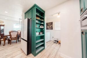 Kitchen with green pantry and dining area.
