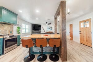 Modern kitchen and dining area with stools.
