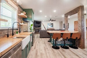 Modern kitchen with island and seating area.