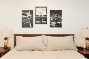 Bedroom with airplane-themed wall art.