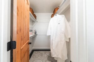 Walk-in closet with robe and shelves.