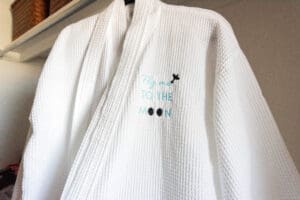 White robe with embroidered moon design.