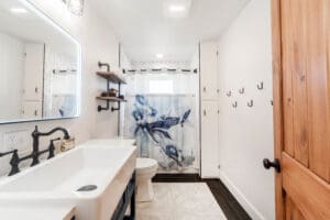 Modern bathroom with airplane-themed shower curtain.