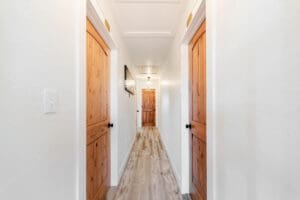 Hallway with wooden doors and light fixture.