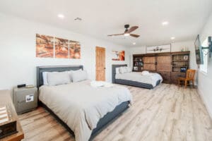 Spacious bedroom with two beds and decor.