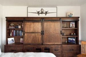 Wooden cabinet with airplane photo above.