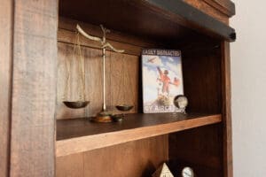 Wooden shelf with scales and airplane poster.