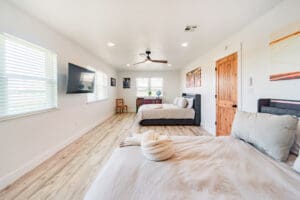 Spacious bedroom with two beds and decor.