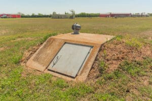Storm shelter in a grassy field.