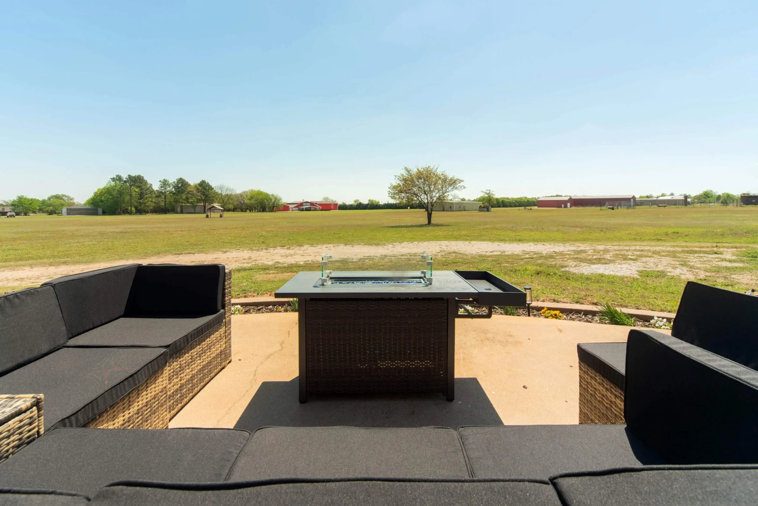 Outdoor patio with black seating and table.